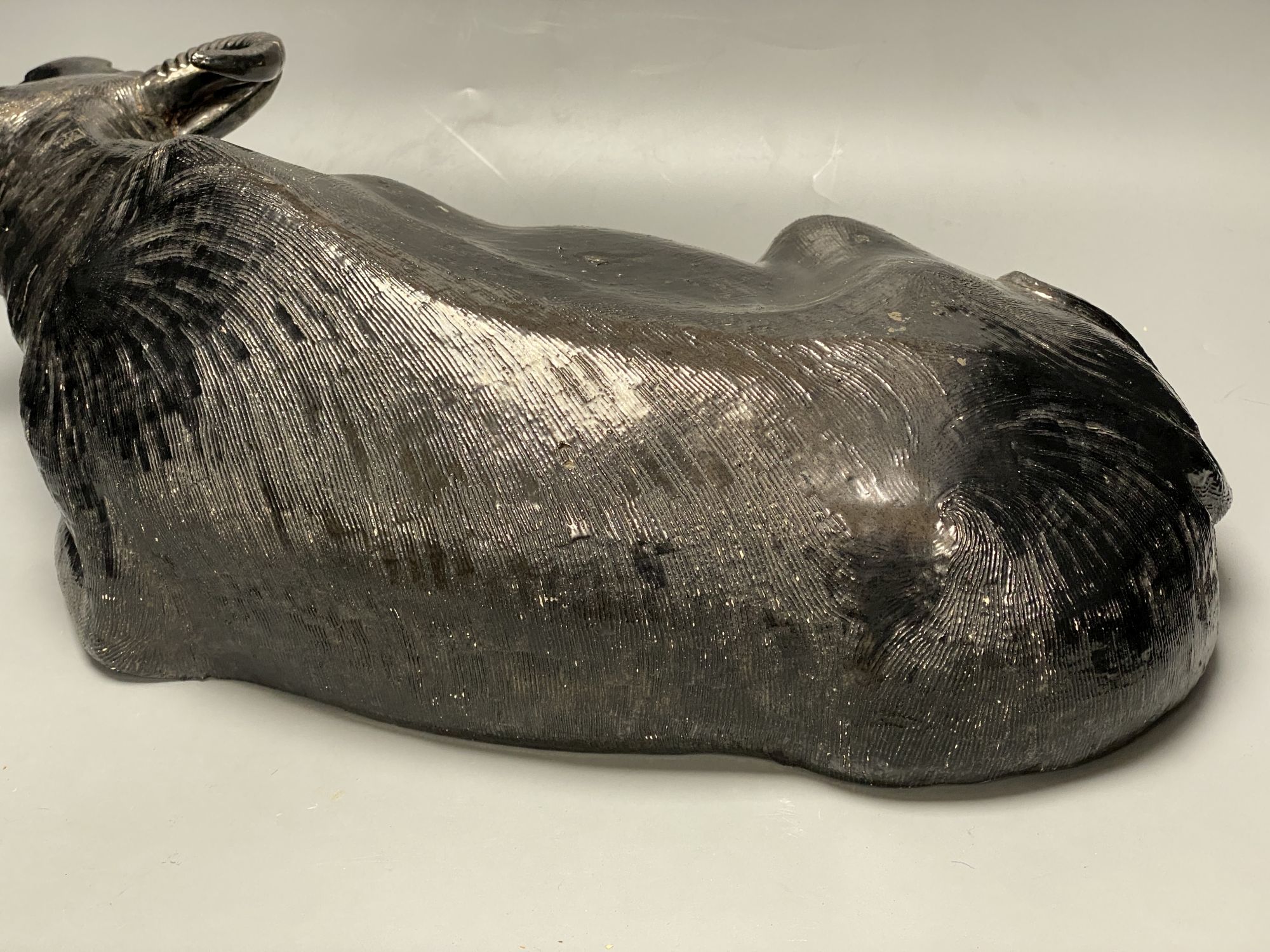 A Chinese pottery model of a recumbent buffalo, length 56cm